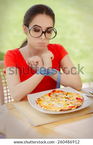 Funny Hungry Woman with Hands Tied with Measure Tape - Beautiful girl on diet trying to eat a pizza
