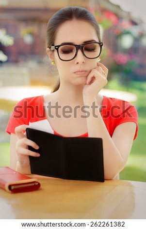 Sad Woman Checking Restaurant Bill - Beautiful girl feeling unhappy about the receipt and having money problems