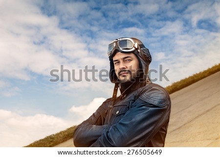 Retro Pilot Portrait with Glasses and Vintage Helmet - Image of a handsome and confident aviator man
