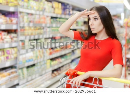 Curious Woman Shopping  at The Supermarket - Portrait of a young girl in a market store with a shopping cart