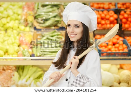 Happy Lady Chef with Big Spoon Shopping for Vegetables - Portrait of a young female cook in a grocery store