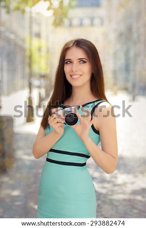 Happy Elegant Woman with Compact Digital Camera - Portrait of a urban young woman holding a mirrorless photo camera