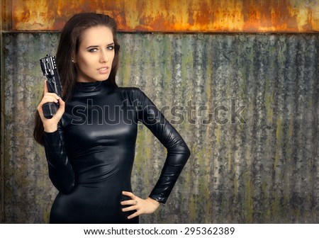 Spy Agent Woman in Black Leather Suit Holding Gun - Portrait of a super heroine in action
