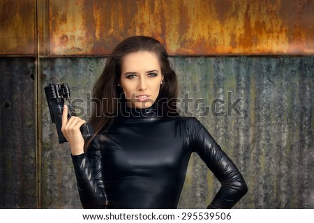 Spy Agent Woman in Black Leather Suit Holding Gun - Portrait of a cool super heroine in action