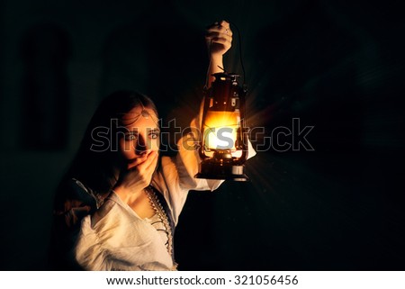 Scared Medieval Princess Holding Lantern - Portrait of terrified woman wearing a vintage dress holding a lamp