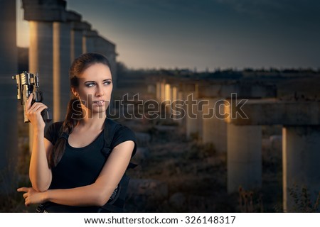 Powerful Woman Holding Gun Action Movie Style - Portrait of a girl in a heroine cosplay  accessorized costume