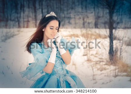 Beautiful Snow Queen in Winter Decor - Portrait of a happy beautiful Renaissance queen in blue royal dress