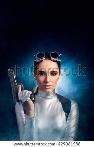 Woman in Silver Space Costume Holding Pistol Gun - Portrait of sci-fi retro futuristic girl with firearm