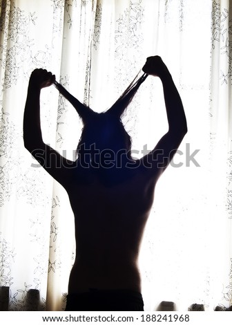 man pulling his hair in shadow ,angry man ,man  silhouette,angry concept