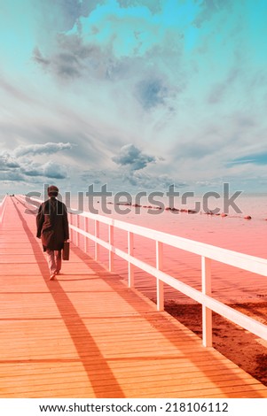 A man goes on the wooden pier. abstract background,imaginary landscape