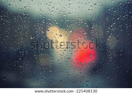 rainy days,rain drops on the window with traffic blur