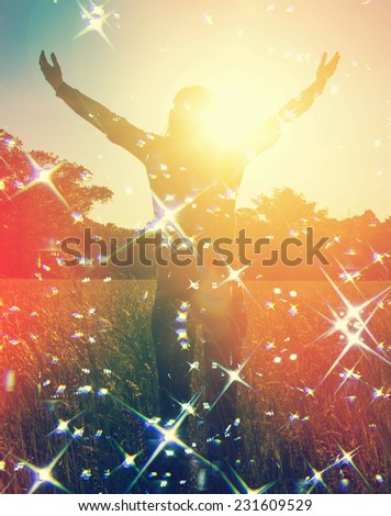 Happy woman with her arms wide open and with joy and inspiration facing the sun,sun greeting,freedom ,freedom concept