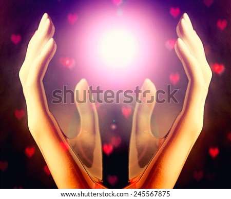 Hands of woman praying to the light,heart bokeh background