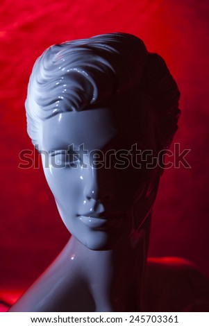 mannequin female doll  head and red light background
