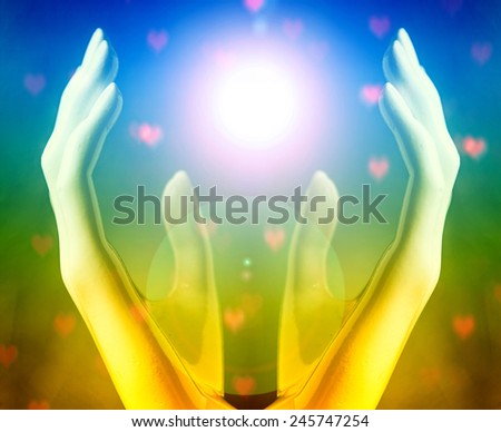Hands of woman praying to the light
