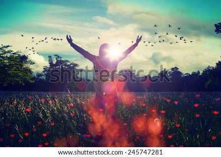 Young girl spreading hands with joy and inspiration facing the sun,sun greeting,freedom concept,bird flying above sign of freedom and liberty,heart bokeh