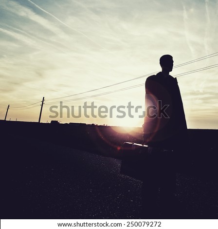 shadow man on empty road in sunset,lonely traveler , freedom concept,outsider,change life ,freedom of choice