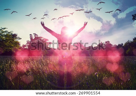Young girl spreading hands with joy and inspiration facing the sun,sun greeting,freedom concept,bird flying above sign of freedom and liberty,red heart bokeh