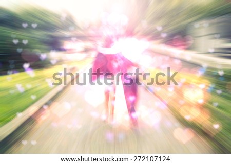 Young happy couple walking in the park, back view,blurry unfocused background,love and happiness ,couple in love walking