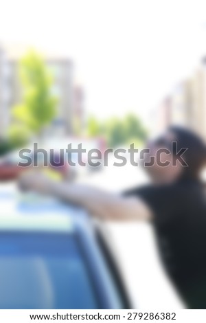 man having trouble with car,blurred background