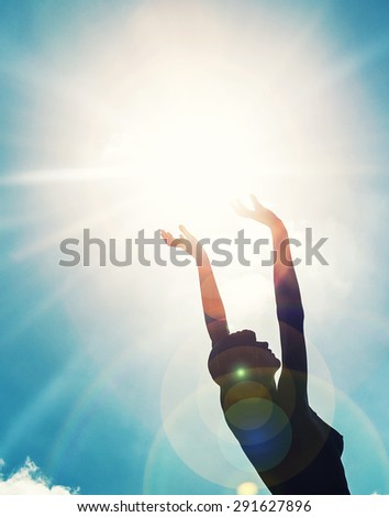 Young woman  with raised hands to the sun  woman silhouette raising hands to the sun ,freedom and liberty concept