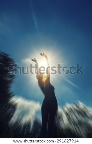 Young woman  with raised hands to the sun  woman silhouette raising hands to the sun ,freedom and liberty concept