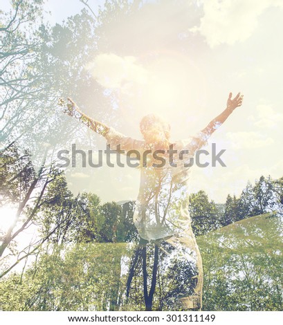 Young girl spreading hands with joy and inspiration facing the sun,sun greeting,freedom concept, sign of freedom and liberty,double exposure forest and girl