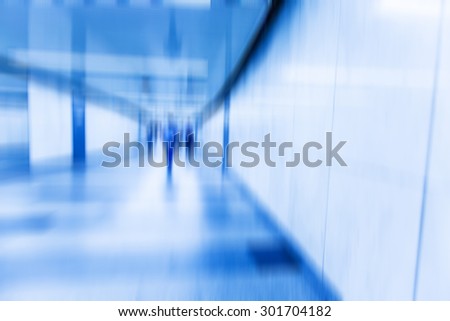 blurred tunnel in metro station,blue tone,with people walking