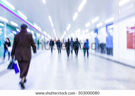 blurry people walking in metro station on rush hour ,