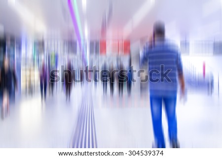 blurry people walking in metro station on rush hour