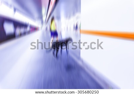 people walking in metro station on rush hour,blurred background