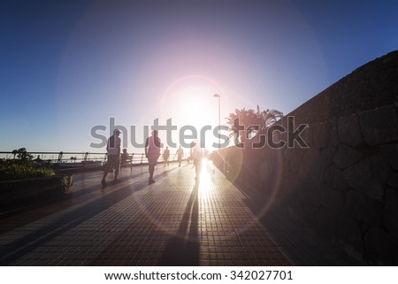 people walking on sunset street,palms and sunset ,