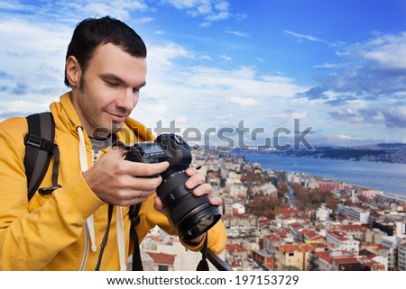 Tourist with a camera photographing landscape in Istanbul, Turkey. Landscape looked like a classic European city.