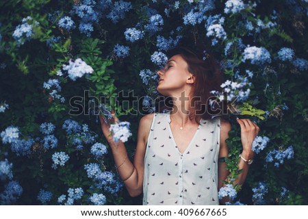 Beauty in Nature. Woman Portrait on flowers background