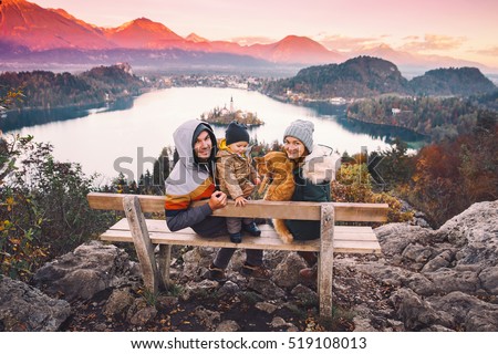 Family travel Europe. Bled Lake at autumn or winter time, Slovenia, Europe. Top view on Island with Catholic Church in Bled Lake with Castle and Mountains in Background.