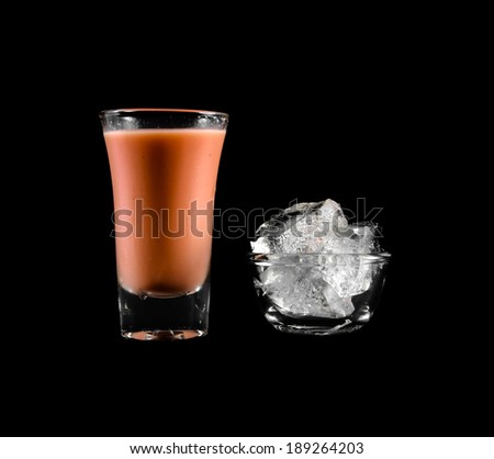 pink water drink in small glass and ice cube isolated on black background
