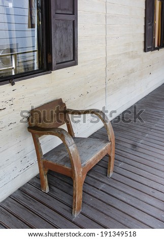 single old wooden chair outdoor at wood pattern balcony