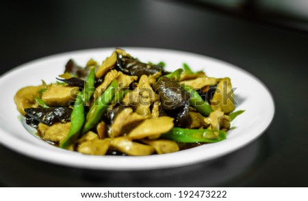 Fried oil with pork, mushroom and cow-pea food on white dish