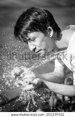 asia young man washing him face and Water splash. with retro filter Stop water liquid at outdoor