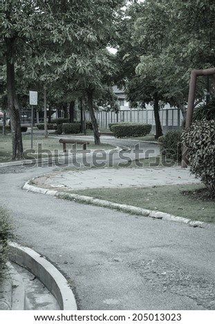 small City tree park with road and footpath at summer outdoor with retro filter