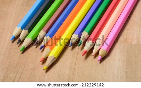 colorful old Color pencils on wood pattern table background