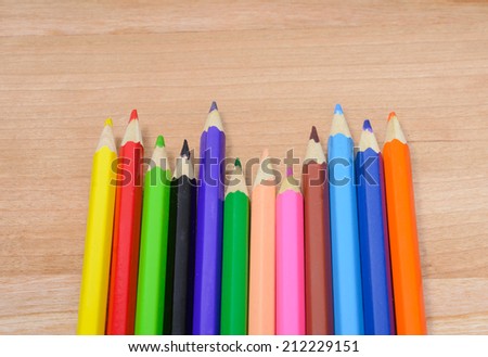 colorful old Color pencils on wood pattern table background