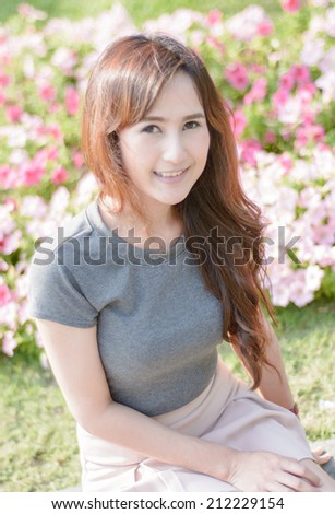 portrait asia young woman smile on summer outdoor at flower garden