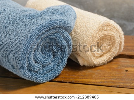 bath towels color fabric on wood table at old metal background