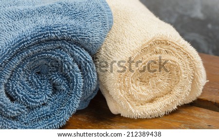 bath towels color fabric on wood table at old metal background
