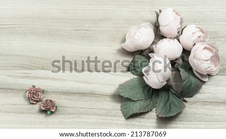 old flowers deco on wooden pattern background with retro filter