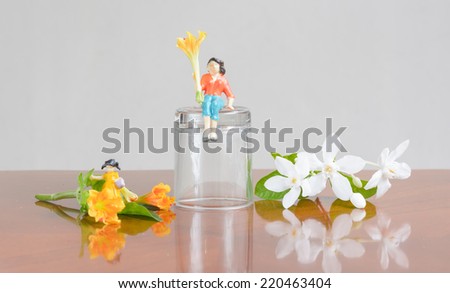miniature family people with a flower  concept resting summer day