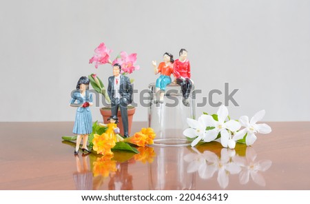 miniature family people with a flower  concept resting day