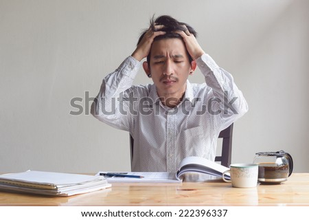 asian depressed business man working at work table