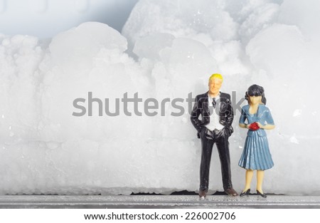 Miniature businessman family work with  stone ice concept winter day
